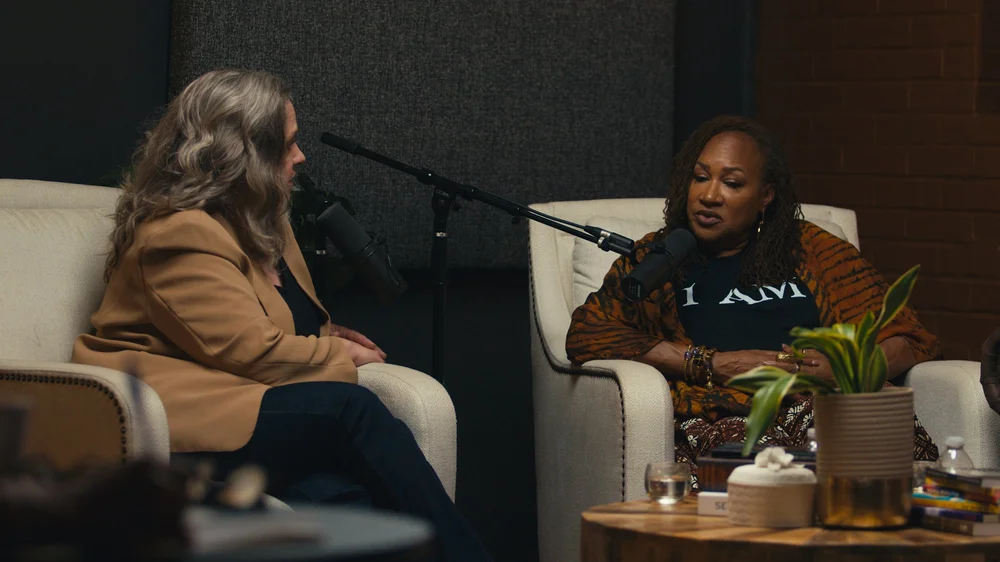 Two people recording a podcast conversation