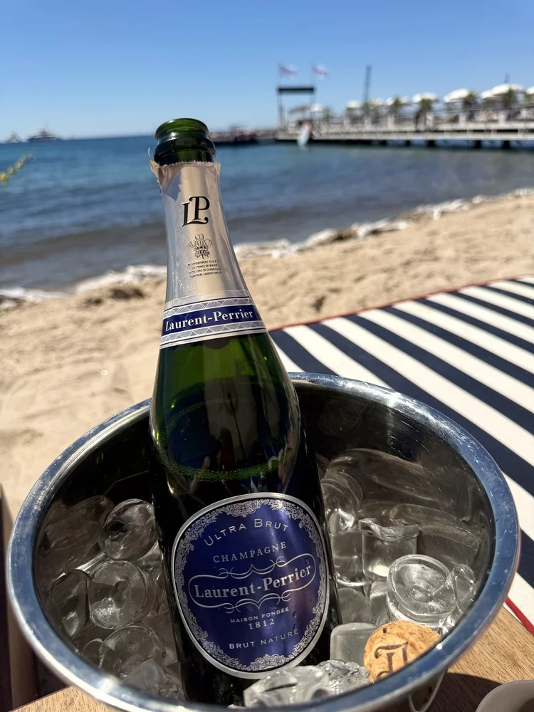 Champagne on ice on a striped beach lounger in Cannes