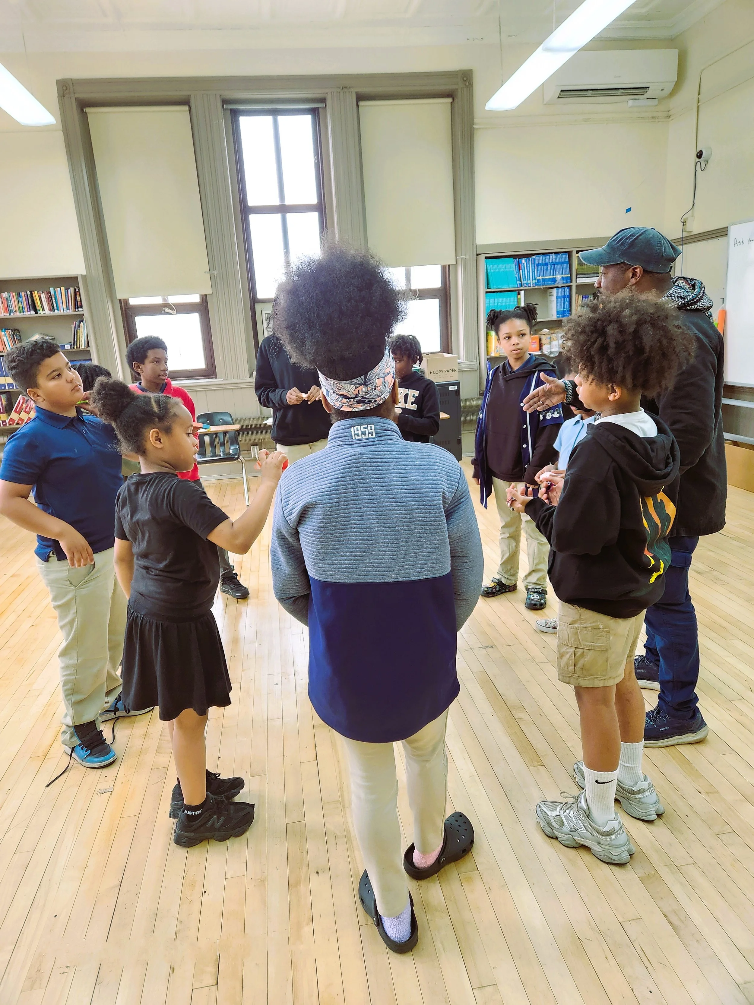 Students and staff gathered in a circle for a group activity