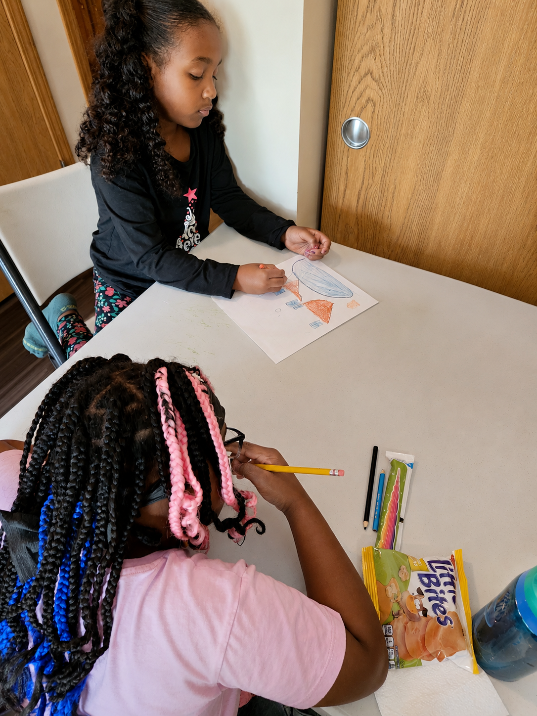 Students drawing and working on an art activity together