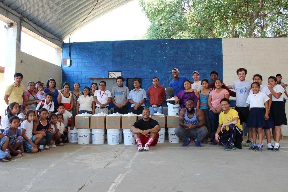Community members receiving Ecofiltro water filtration systems in Guatemala