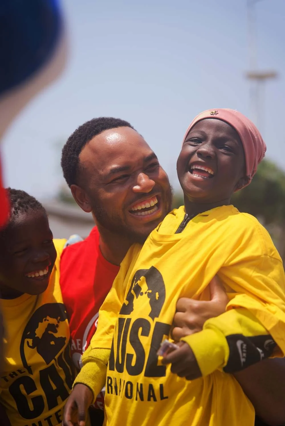 Founder Antoine Taylor laughing with children in Ghana
