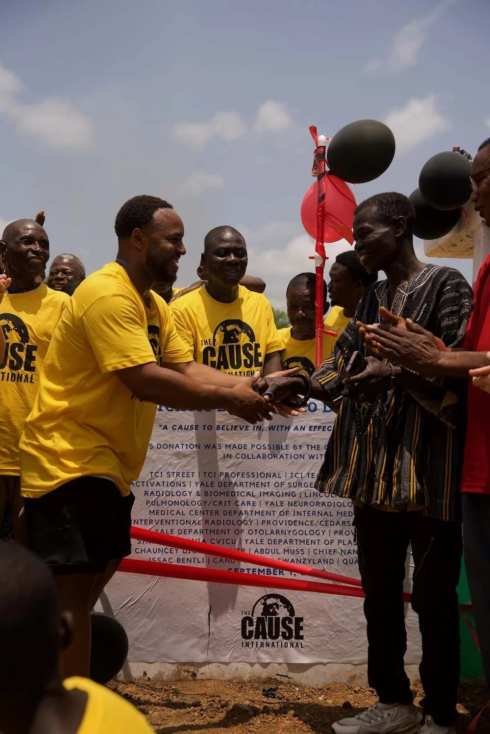 Shaking hands with community leadership at the Dwenantwi borehole dedication