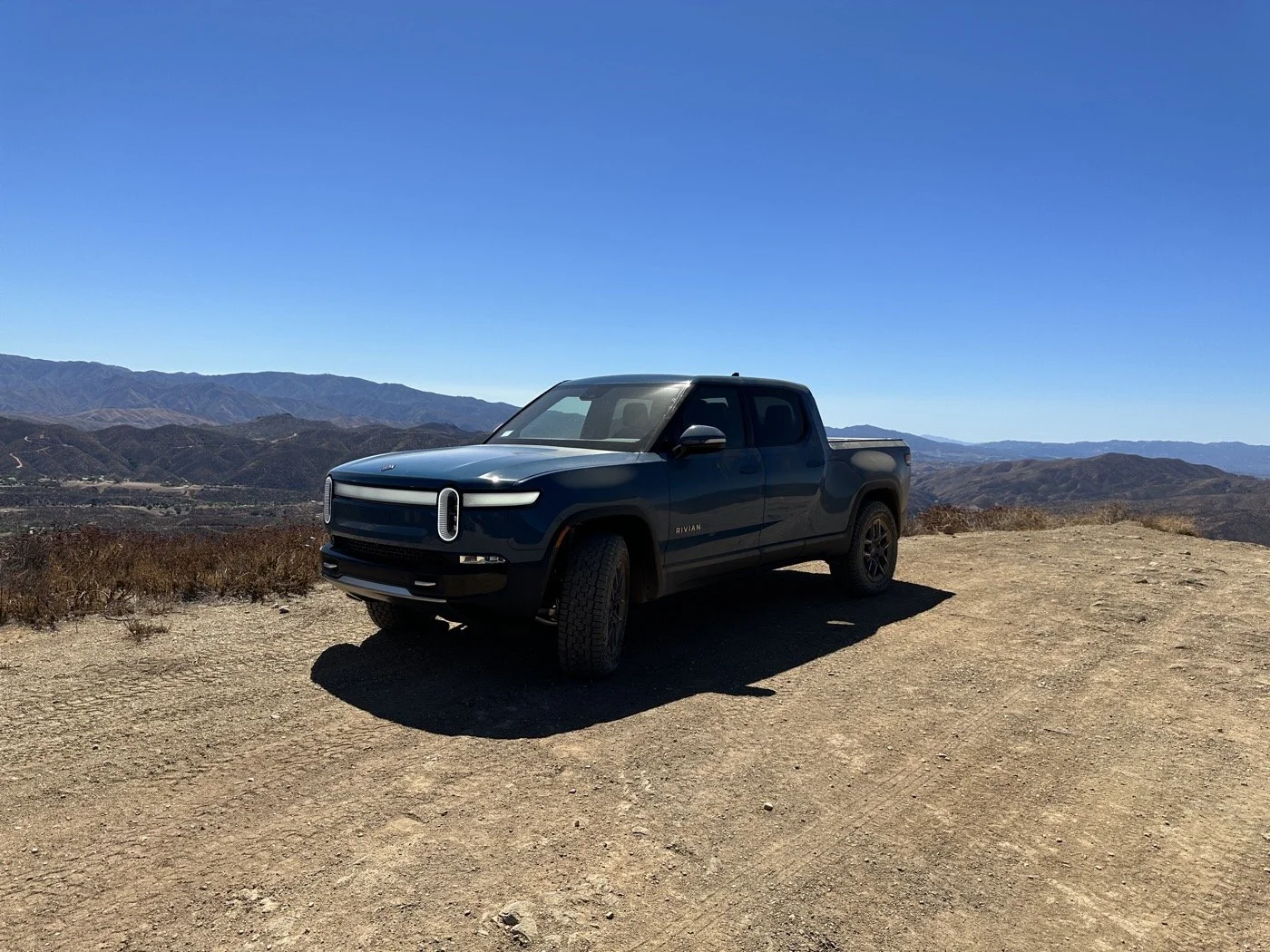 Rivian on a ridgetop dirt road above Los Angeles mountain trails