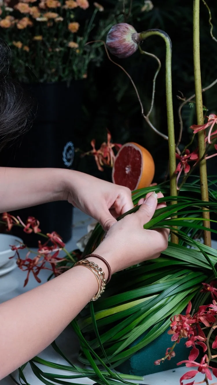 Ginger Flower, hands weaving the arrangement