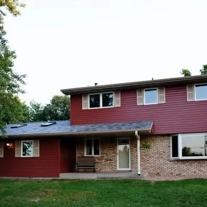 Home with new metal roof, siding, windows and shutters