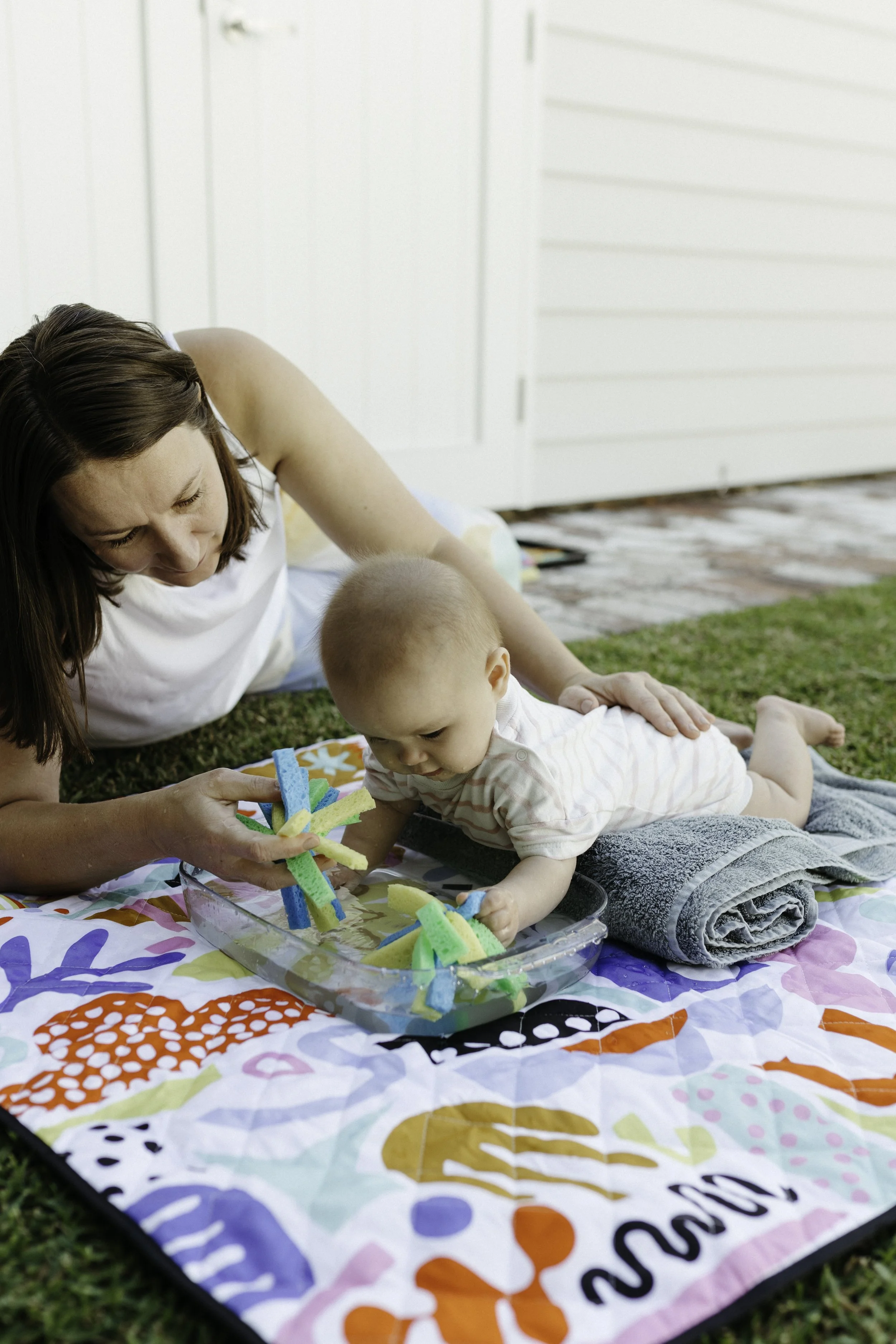 Parent and baby enjoying tummy time play together