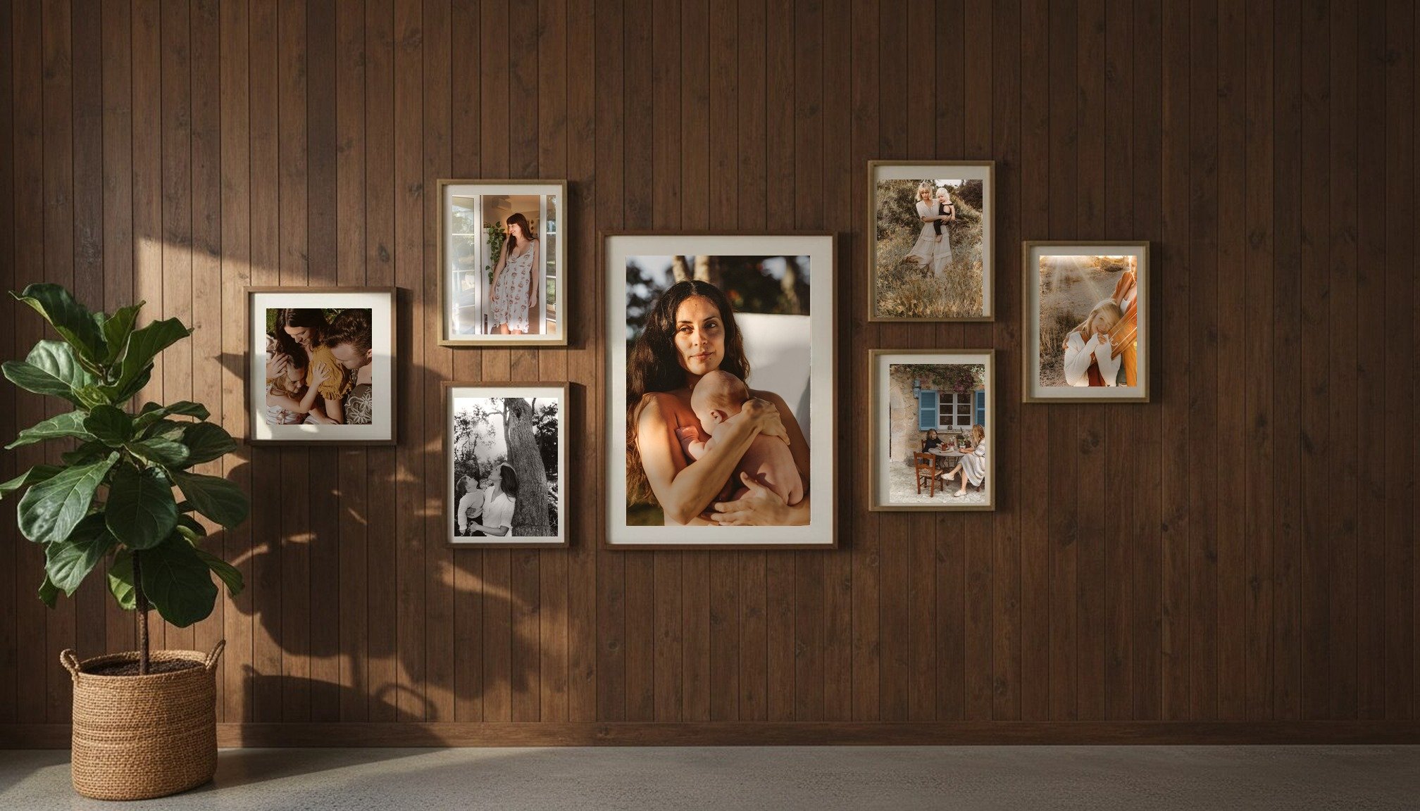 A gallery wall of framed family photographs by Bridget Wood
