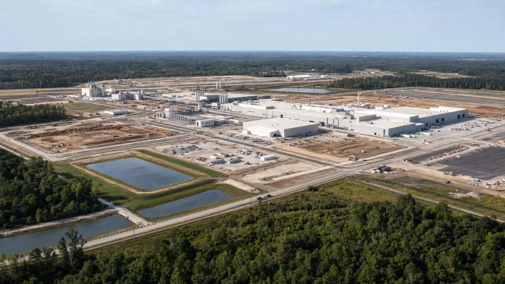 Illustrative aerial view of a large industrial manufacturing campus and stormwater facilities.