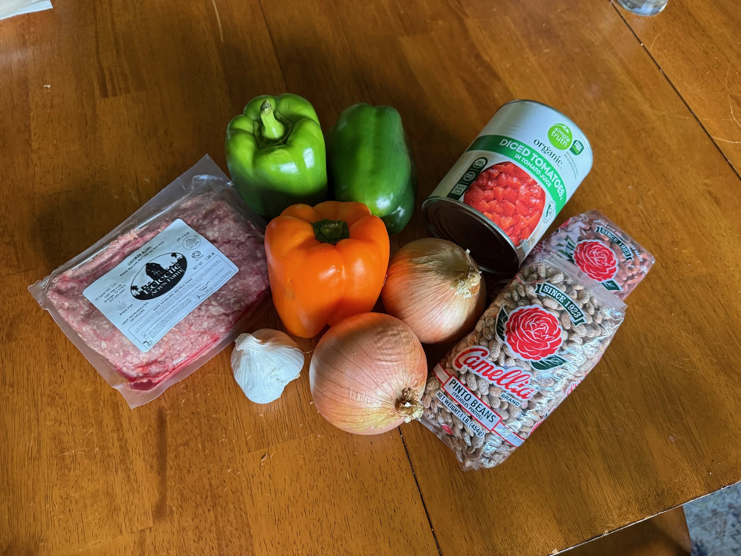 Chili ingredients arranged on a wooden table
