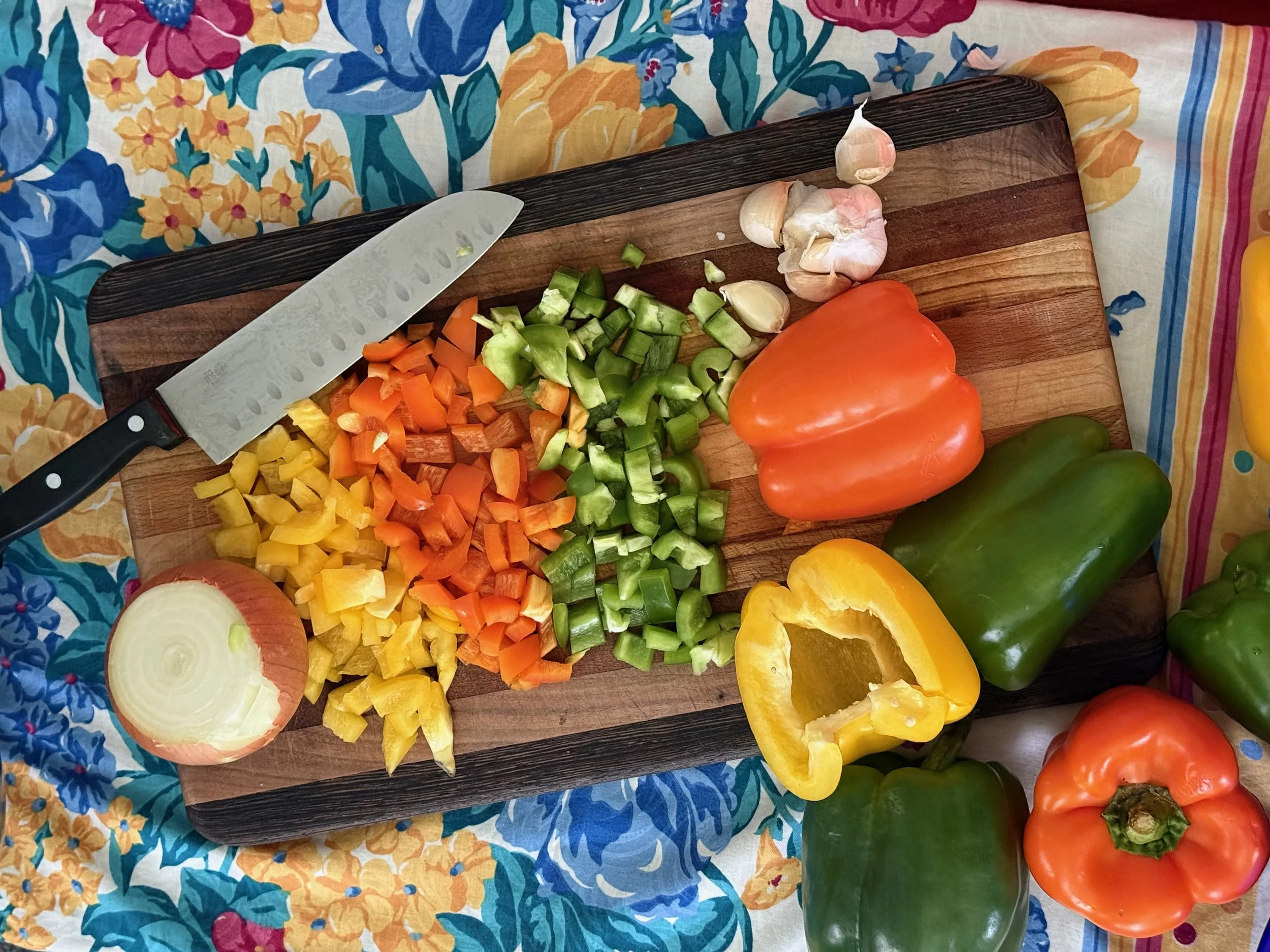 Chopped bell peppers on a cutting board during chili preparation