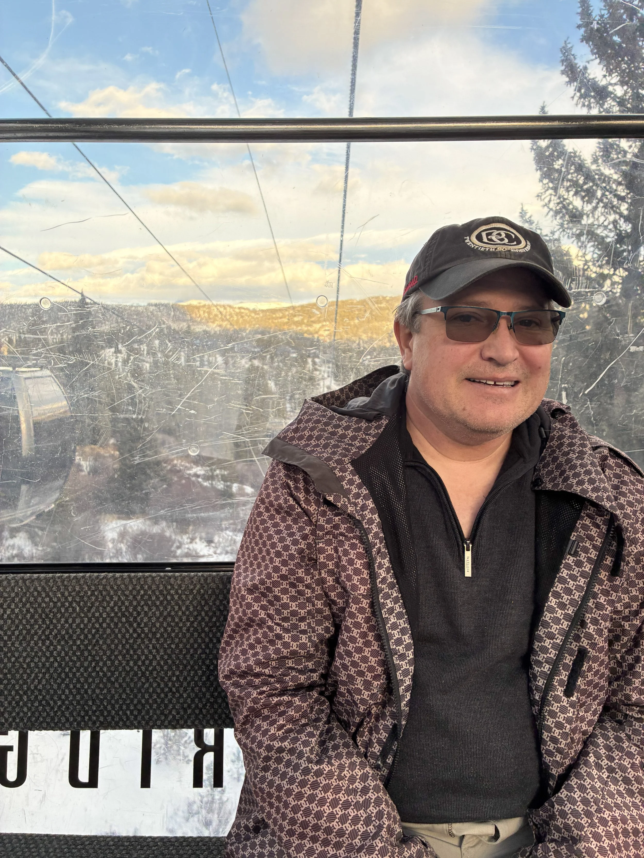 Riding the gondola with a snowy landscape outside.