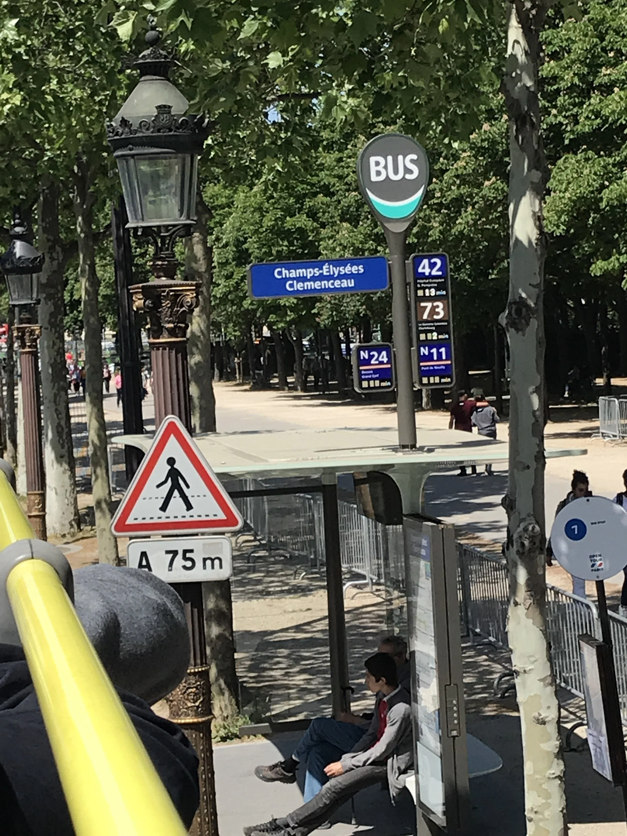A Champs-Élysées–Clemenceau bus stop sign in Paris.