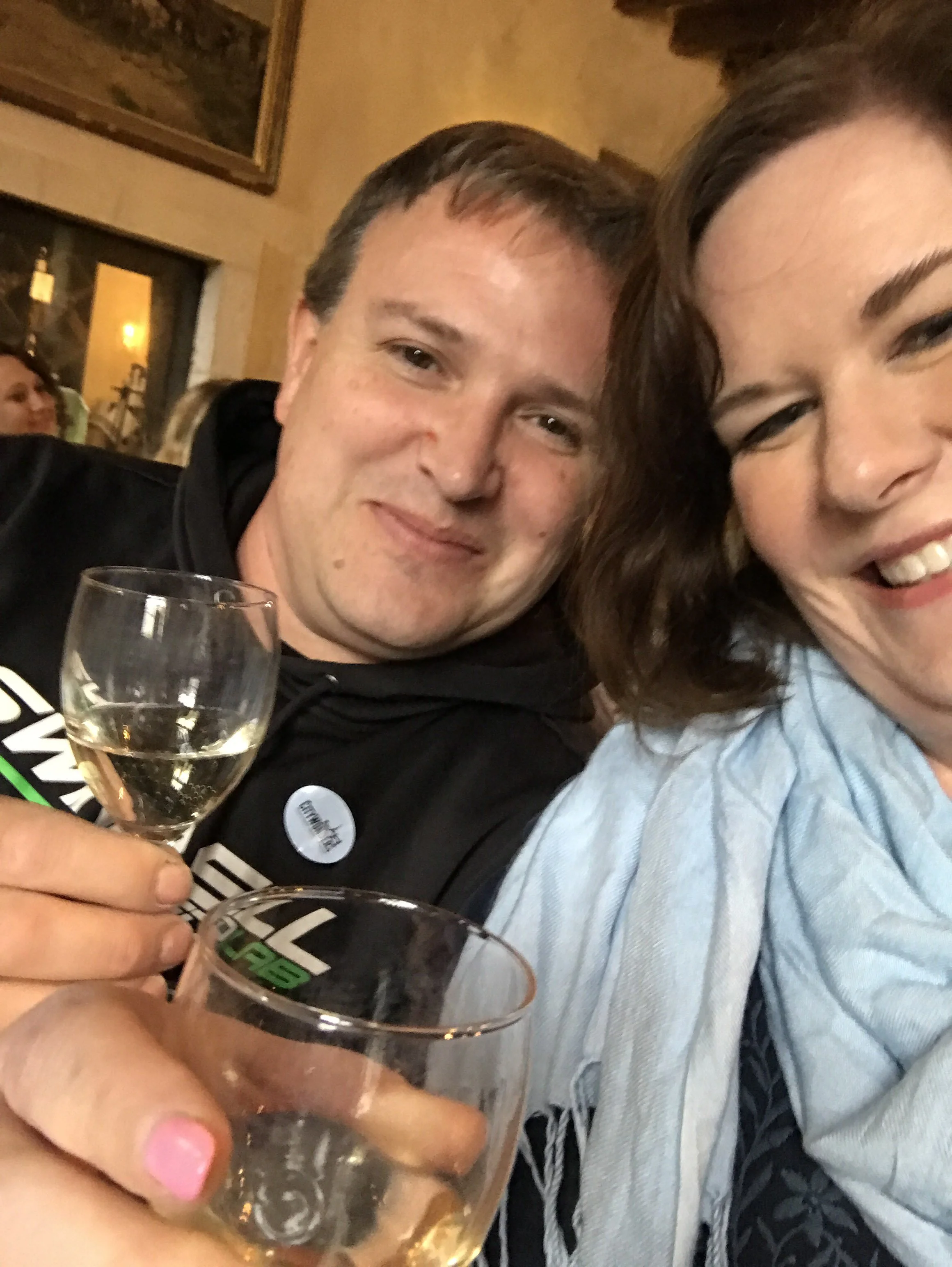A couple toasting with wine glasses.