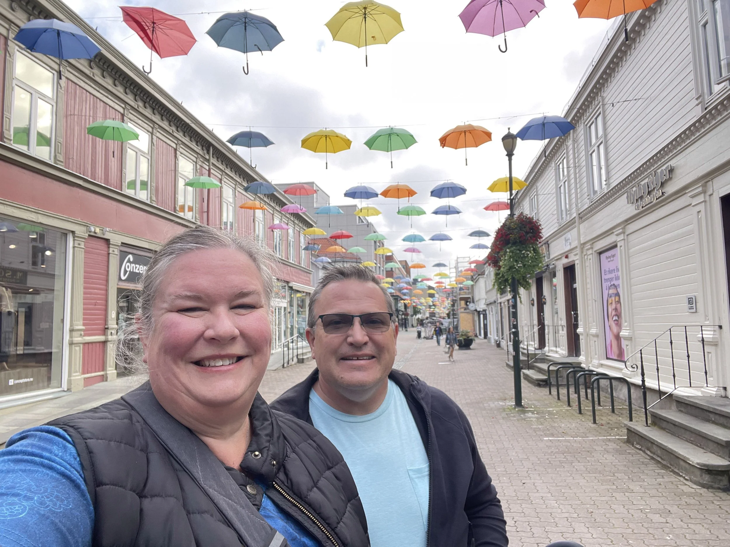 A canopy of colorful umbrellas over a town street.