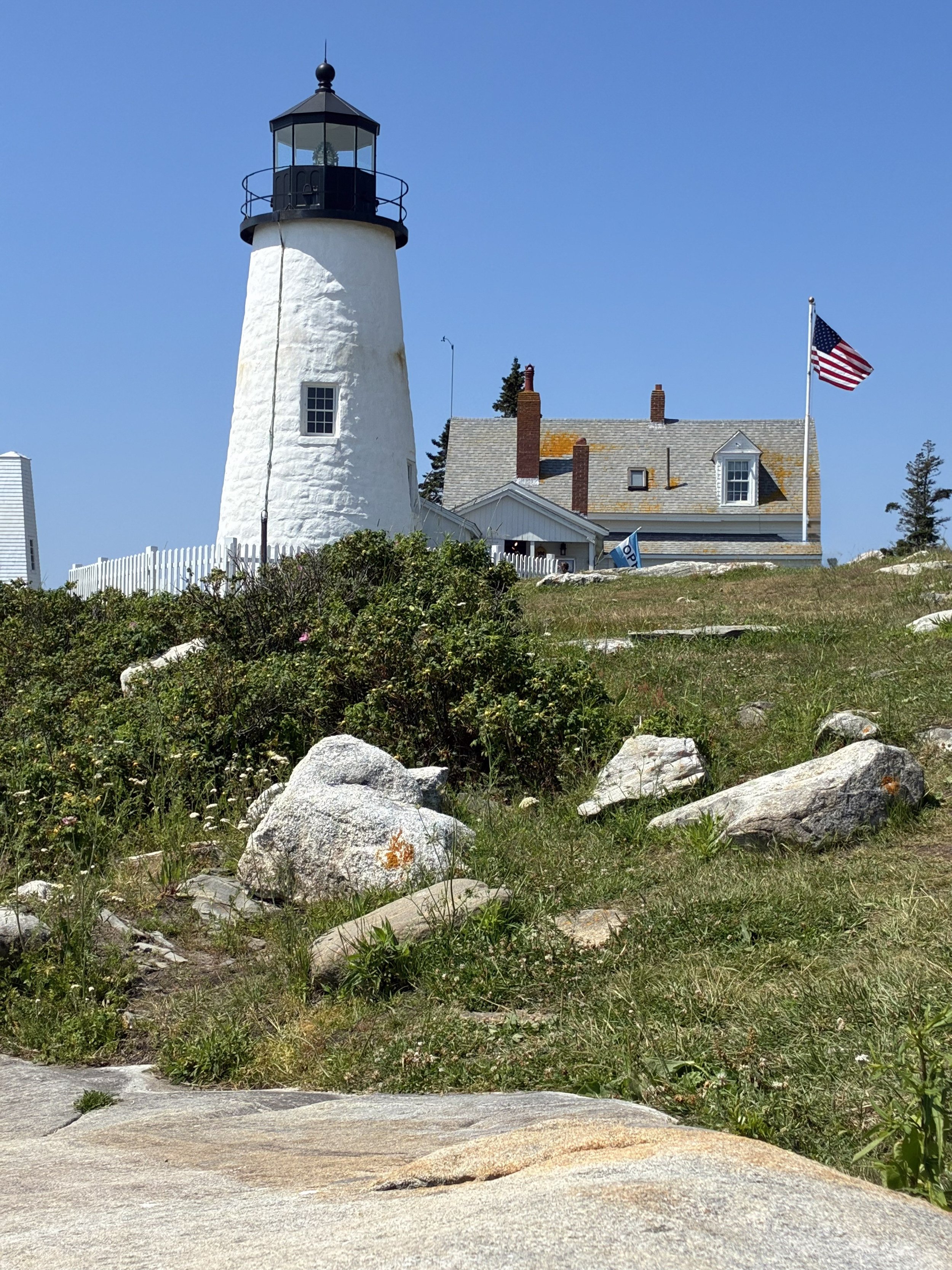 A white lighthouse with its keeper's house.