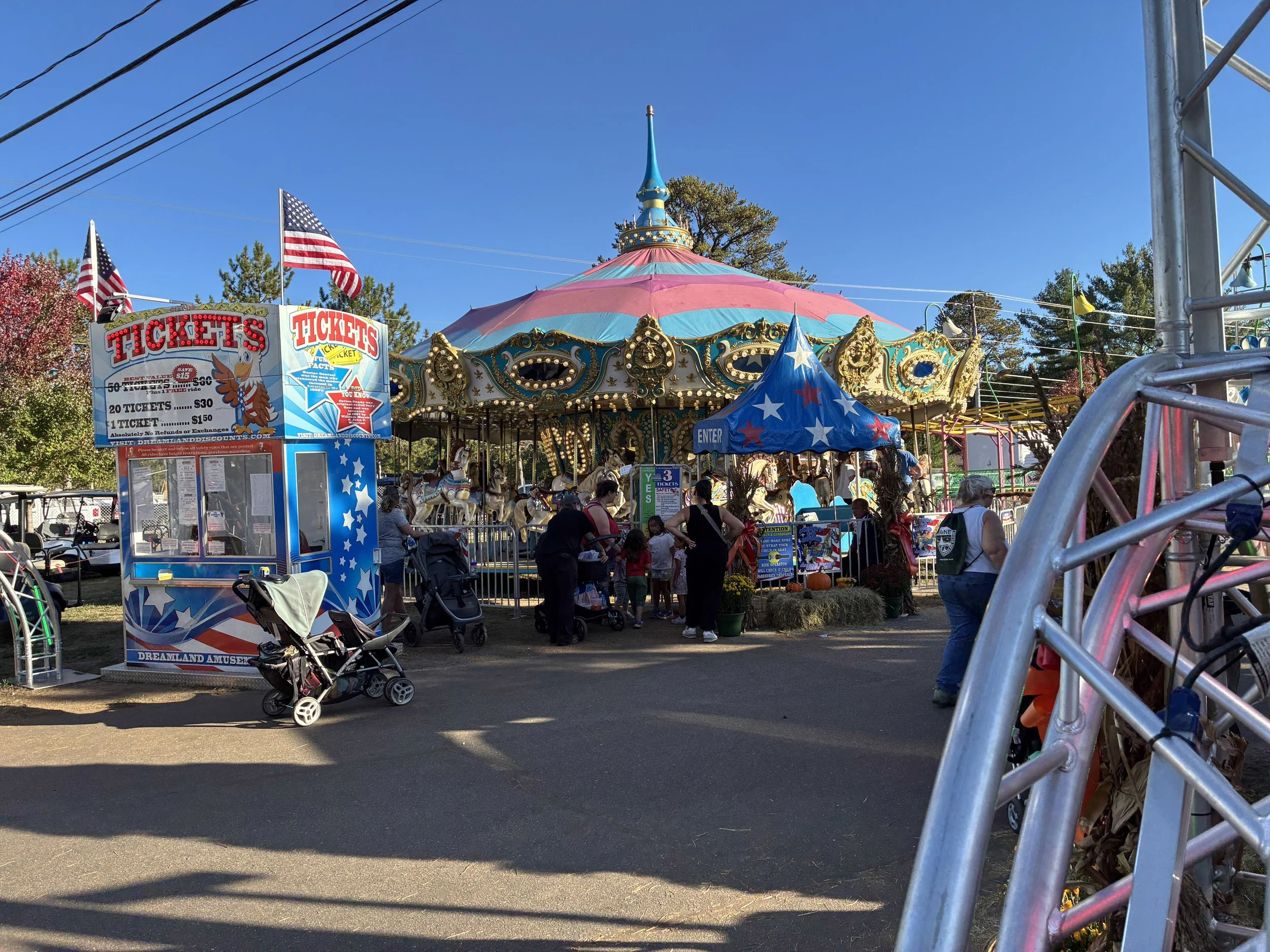 A carousel and ticket booth at a beach-town amusement area.