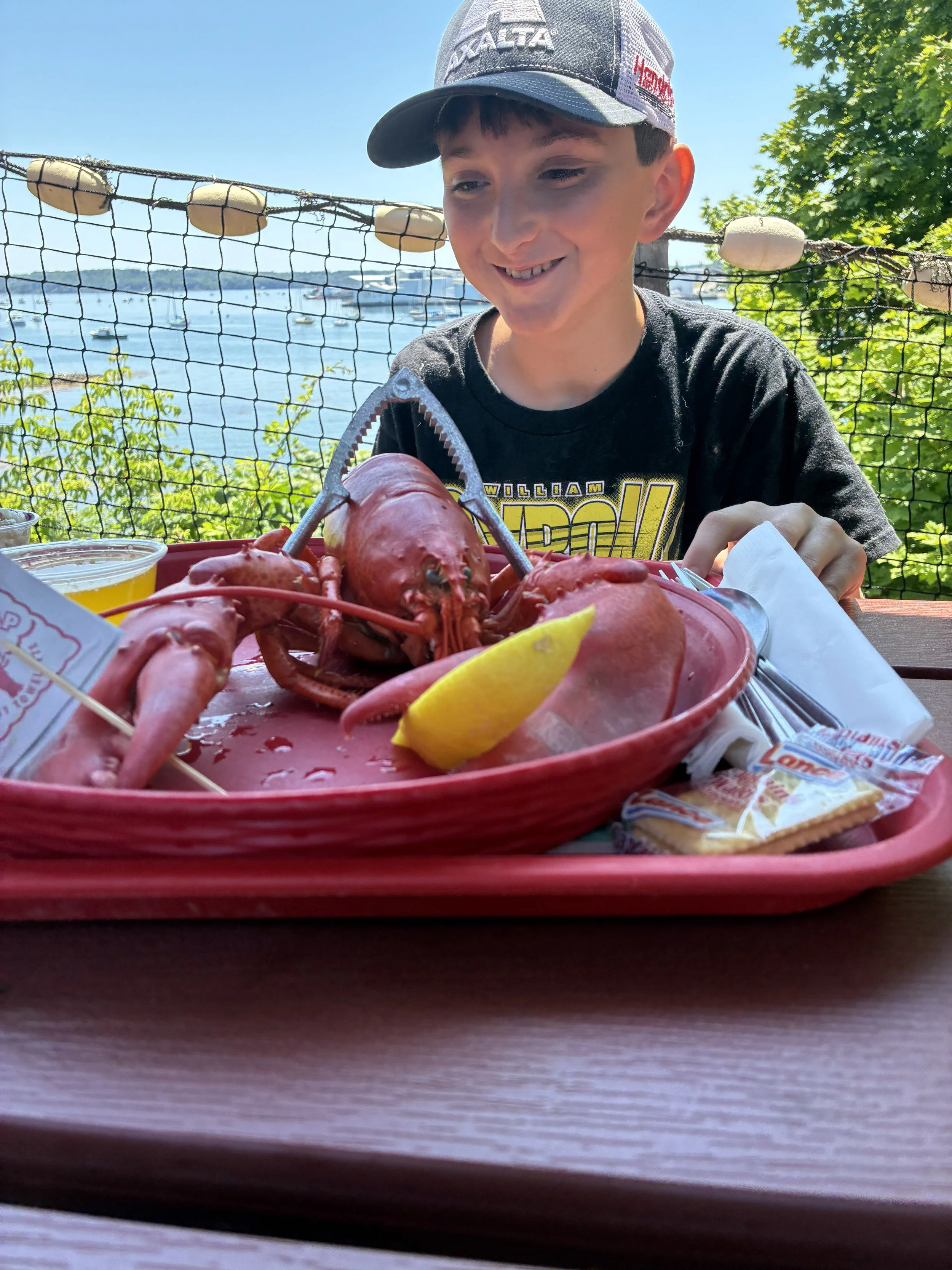 A whole lobster — and a very happy kid.