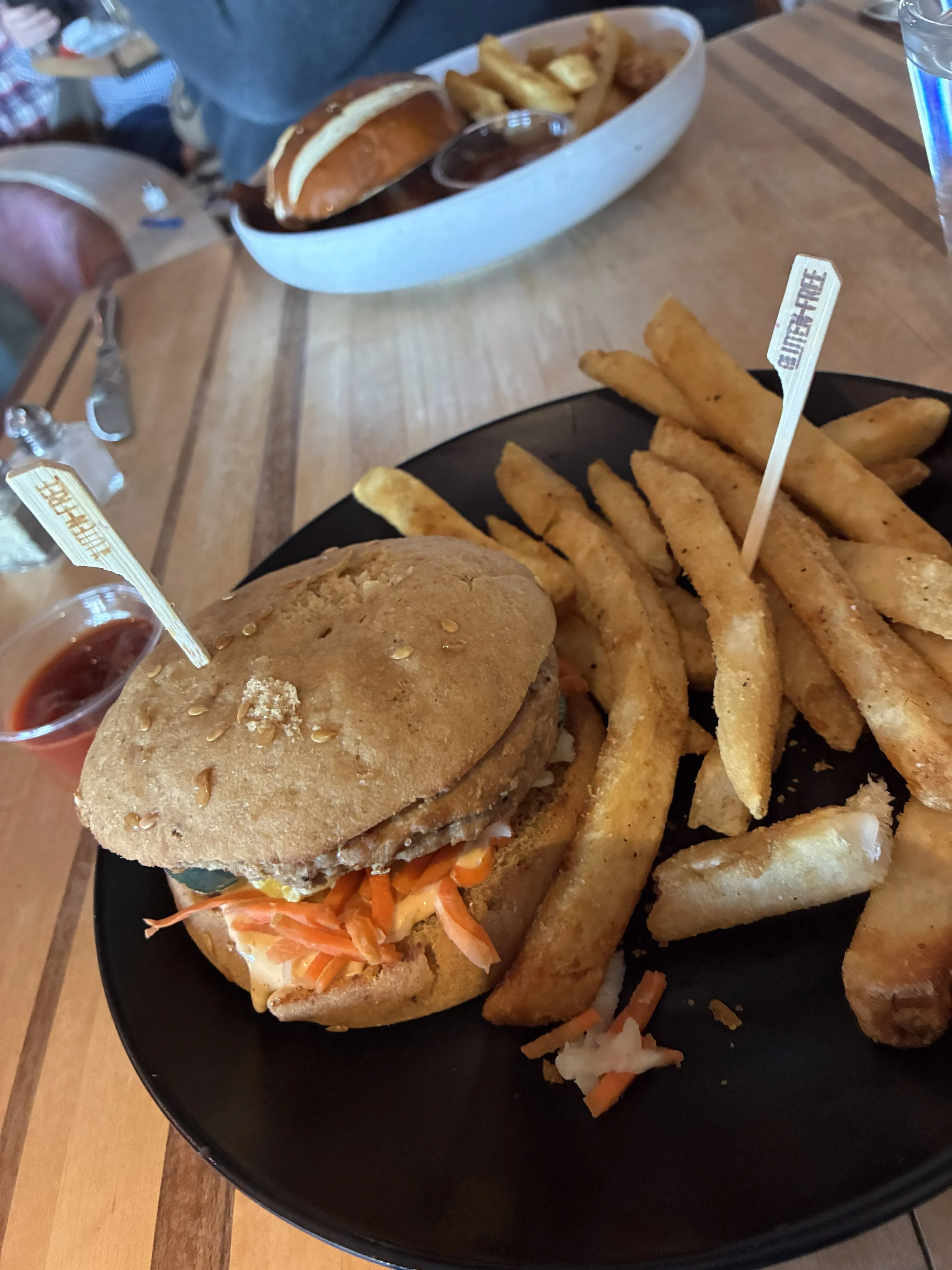 A burger with gluten-free picks and fries.