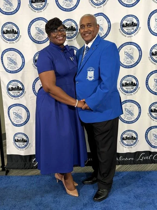 Allie and Soror Lashantah Braswell at the Gamma Delta Sigma chapter backdrop