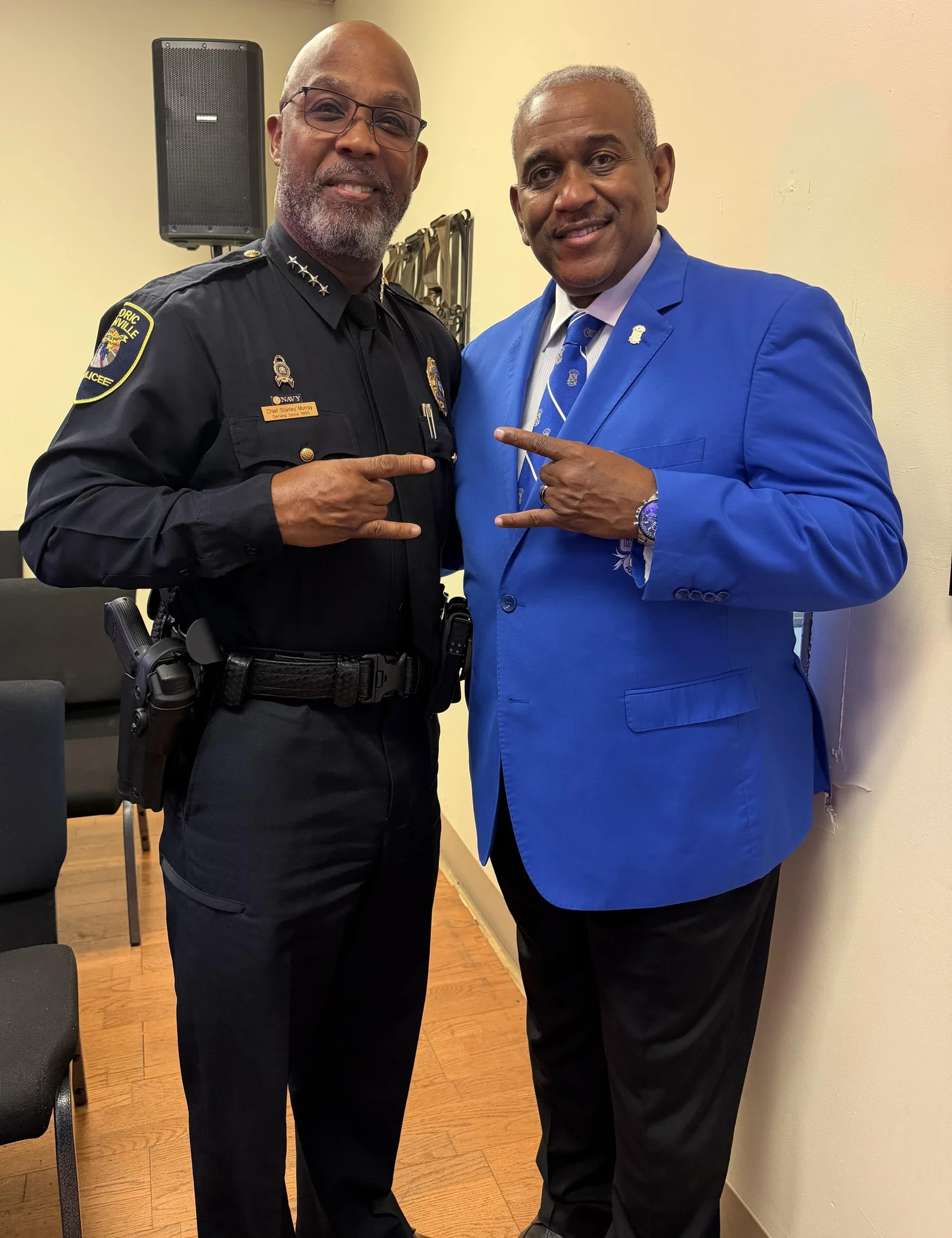 Brother Stanley Murray and Brother Allie L. Braswell, Jr. together, both giving the Sigma hand sign