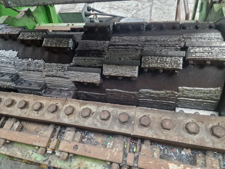 Shredder shaft and teeth with visible rows of hardfacing weld deposits