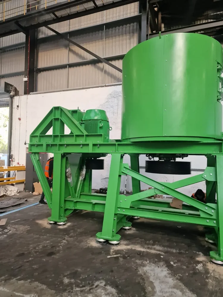 Green processing equipment and drive assembly on a steel frame inside an industrial building