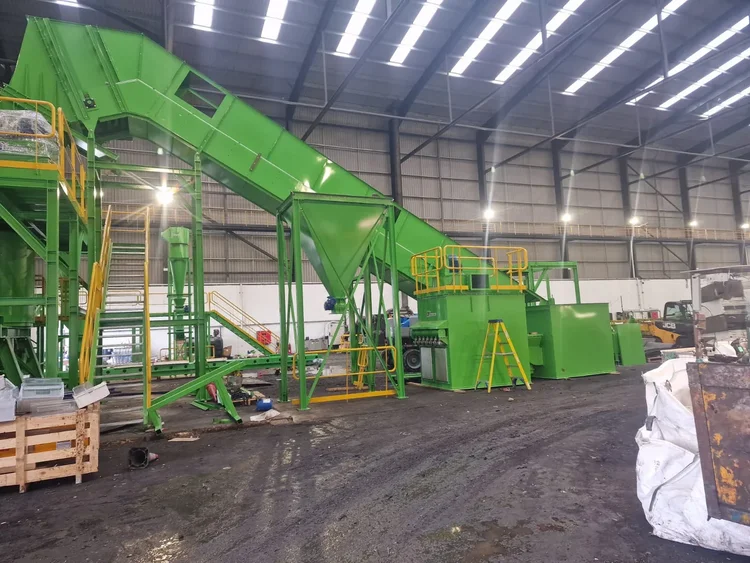 Green processing equipment, conveyors and access platforms during installation inside an industrial building