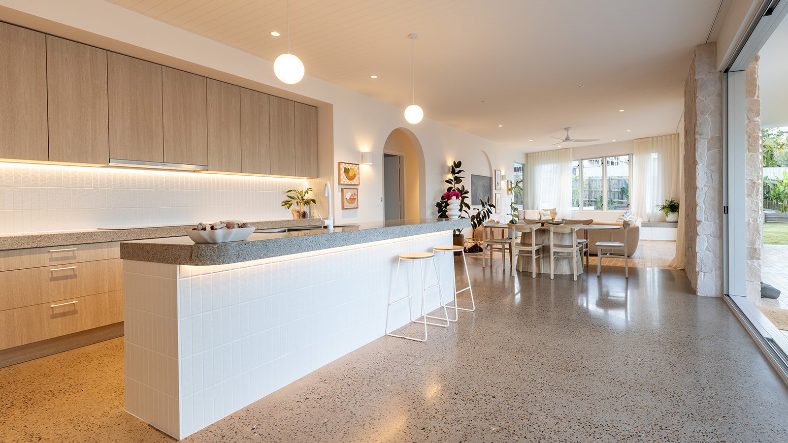 Completed open-plan kitchen, dining and living area with a large door opening