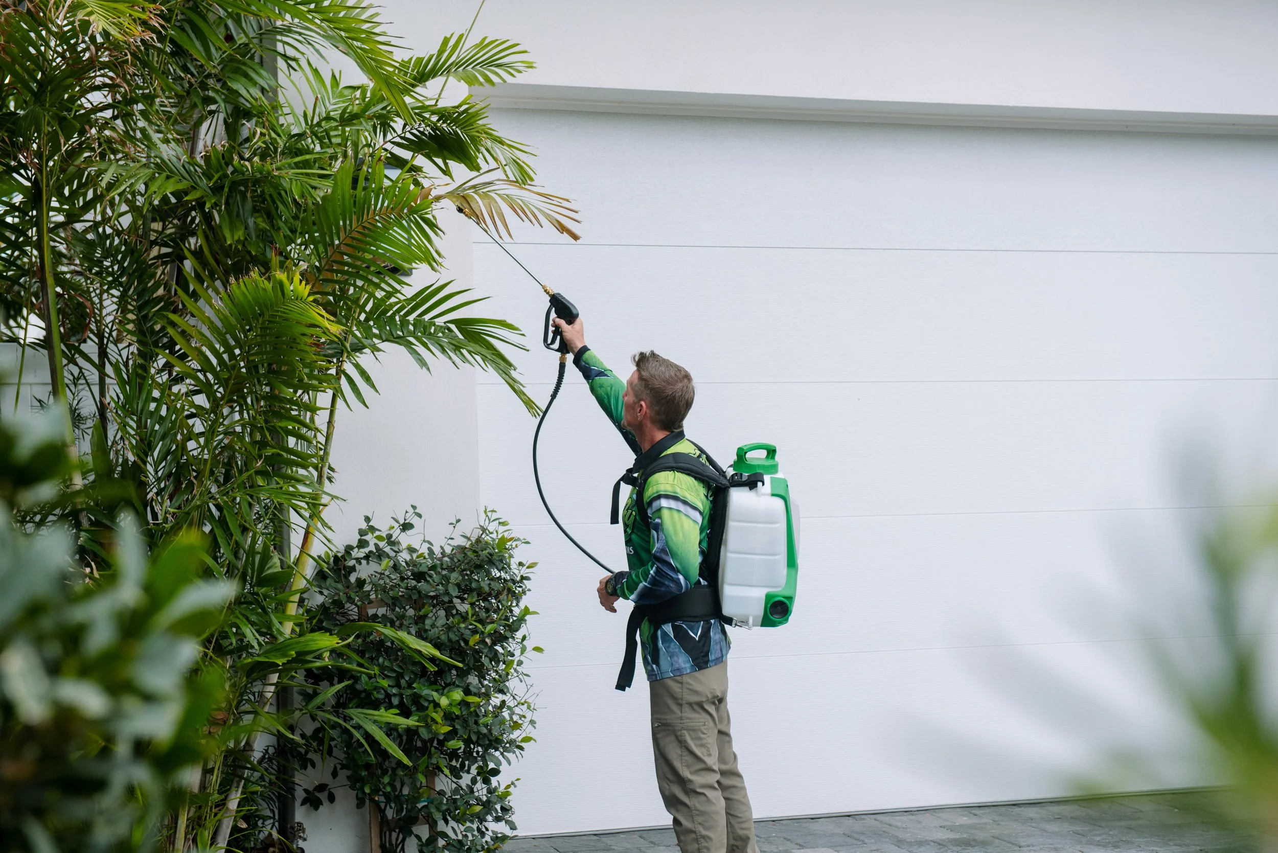 Buggify technician treating the roofline and eaves of a South Florida home