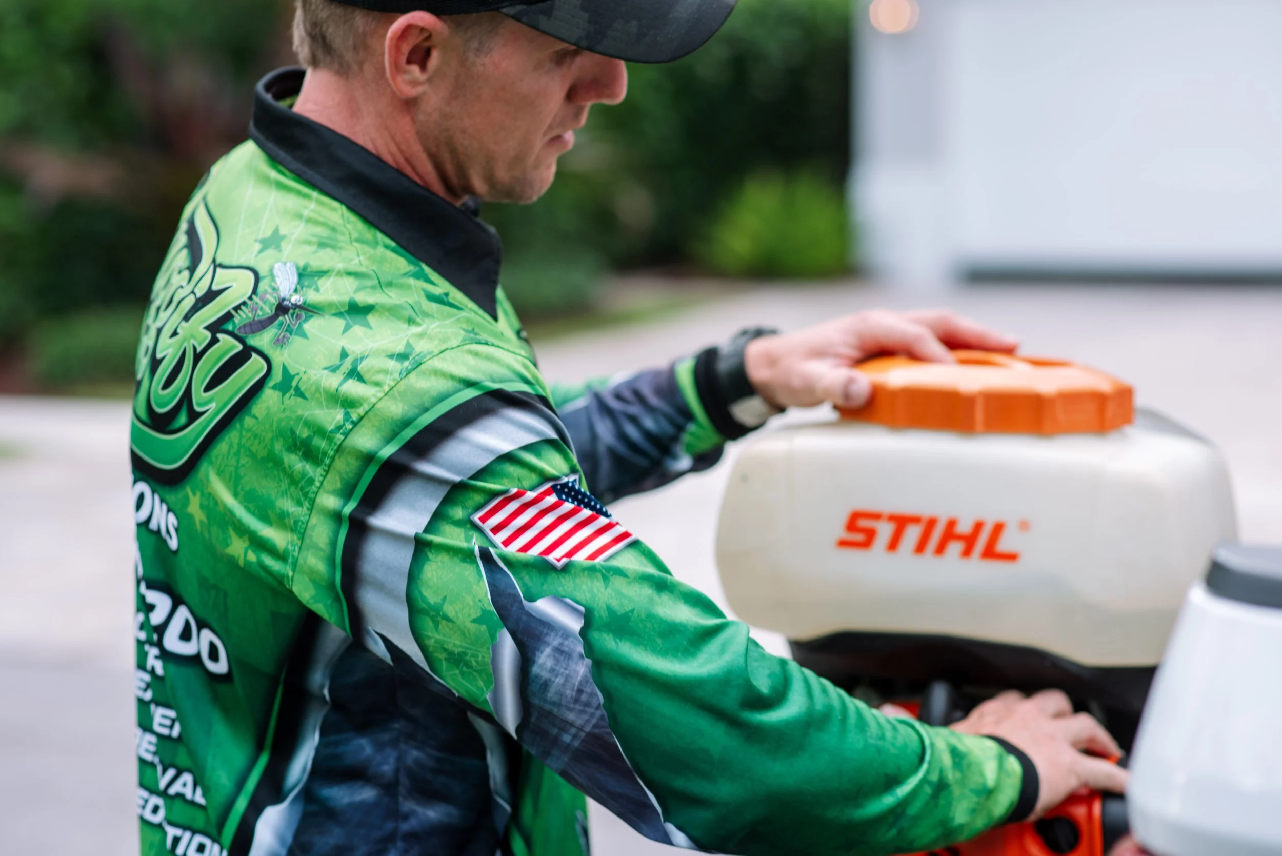 Close-up of a Buggify technician filling a STIHL backpack tank