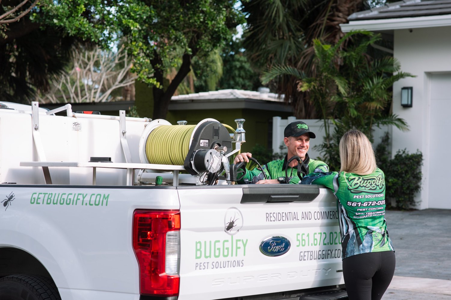 Buggify technician at the truck hose reel talking with a team member