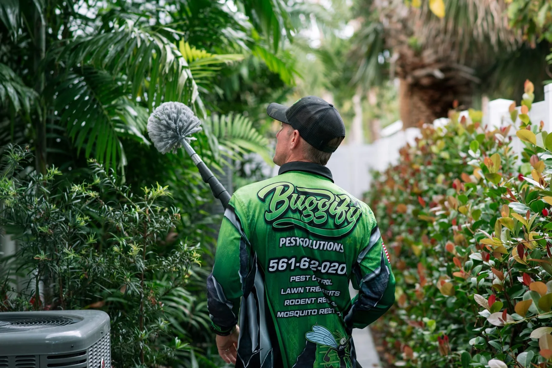 Tyler in the Buggify jersey treating a South Florida yard