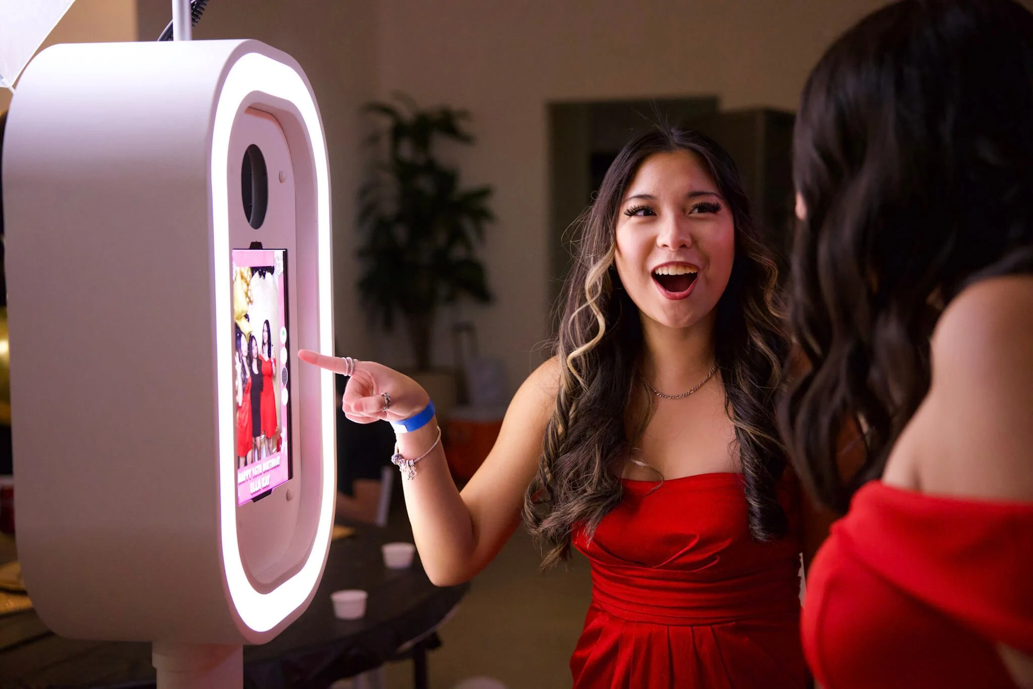 Guests enjoying a BeeCaptured photo booth rental at an event