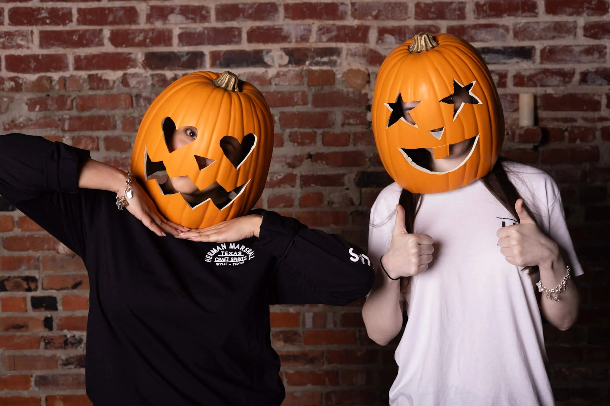 Guests in pumpkin masks posing for a themed photo booth portrait
