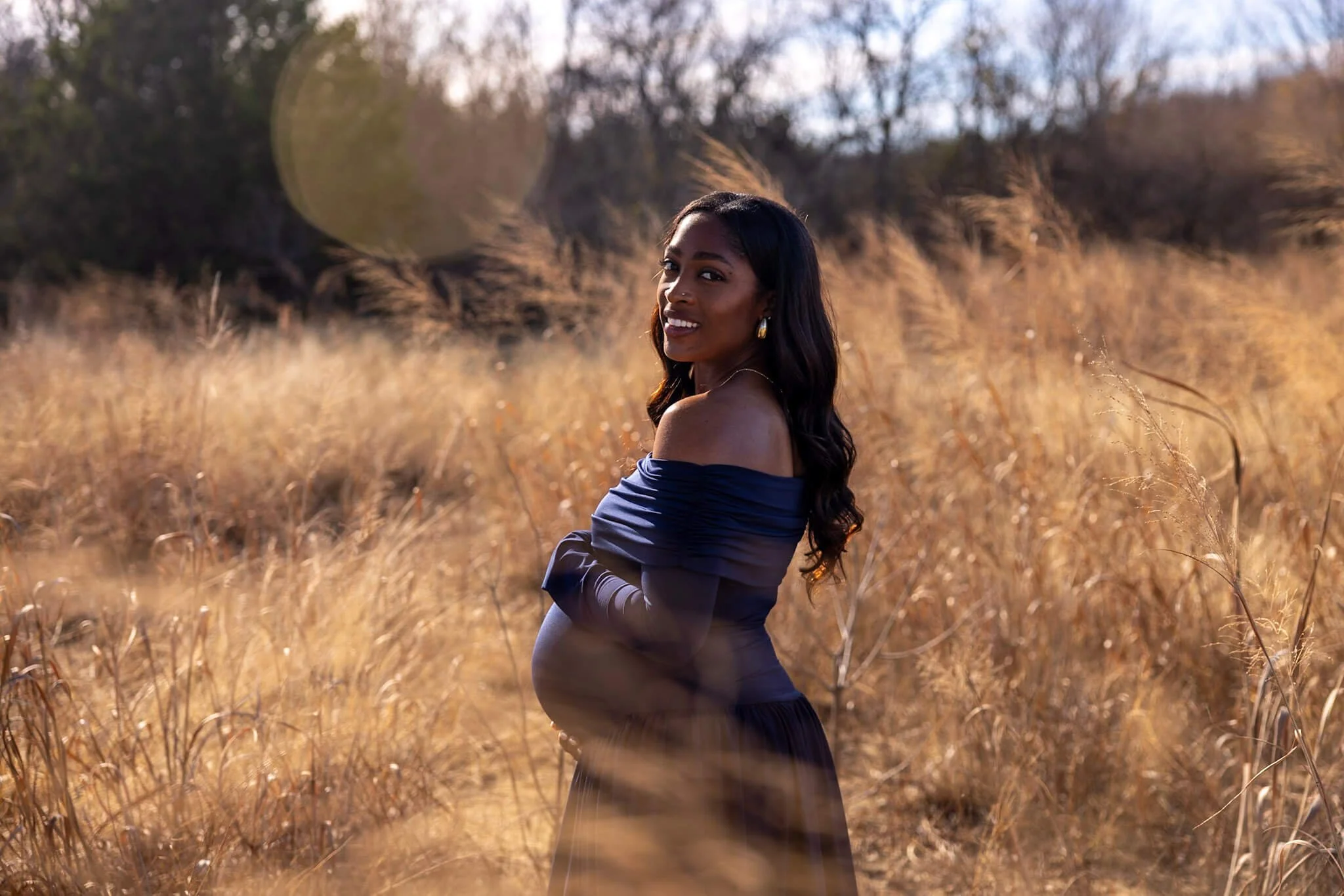 Woman photographed outdoors in a golden field during a BeeCaptured lifestyle portrait session