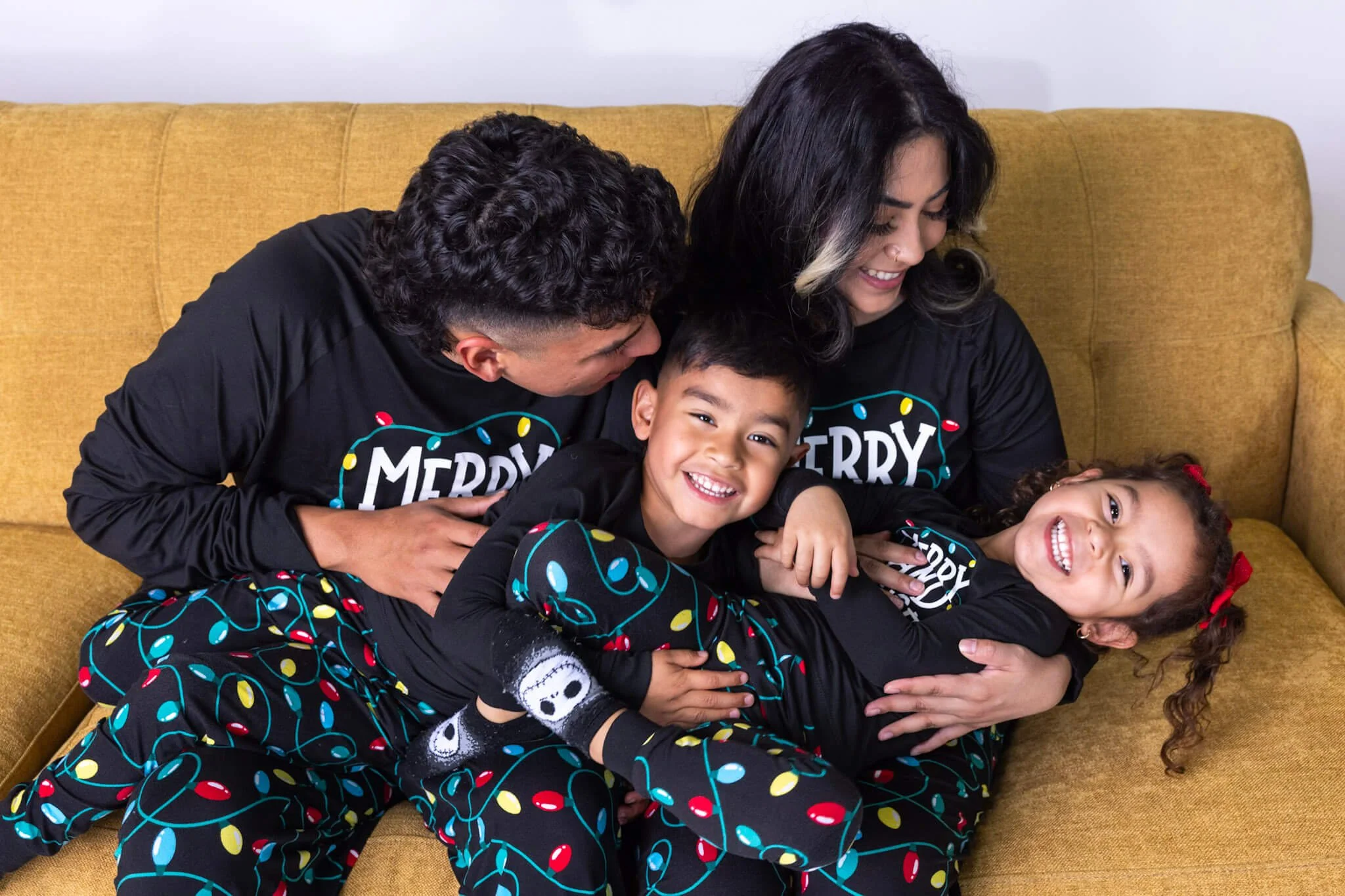 Family sharing a playful candid moment during a portrait session