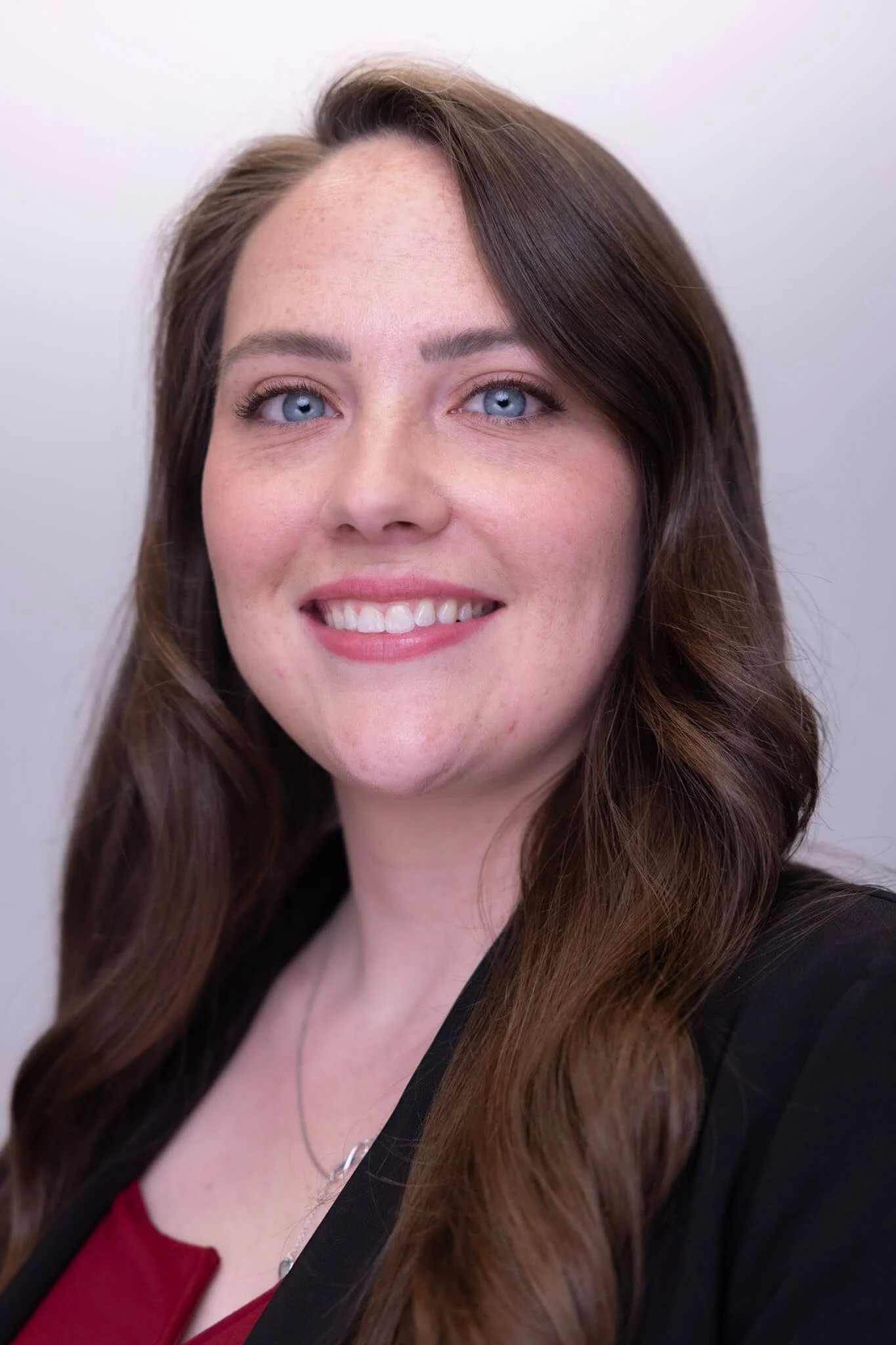 Professional employee headshot with consistent studio lighting
