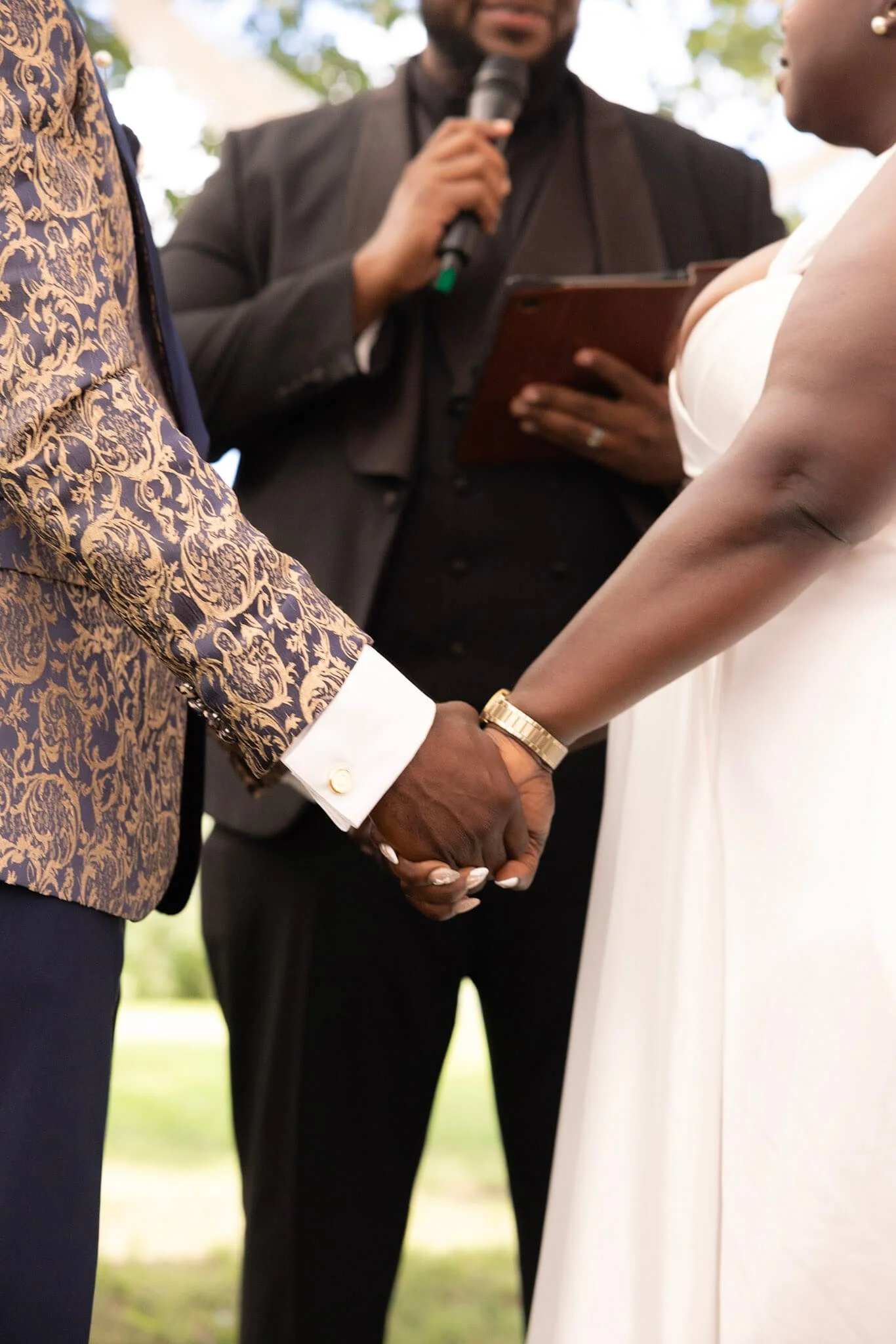 Couple holding hands at the altar during their wedding ceremony photographed by BeeCaptured