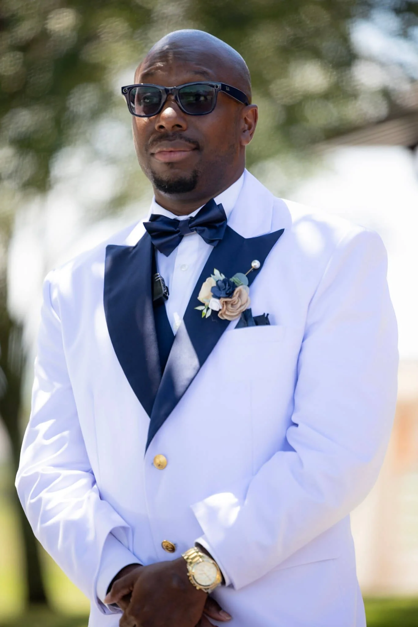 Groom portrait in a white tuxedo photographed outdoors by BeeCaptured