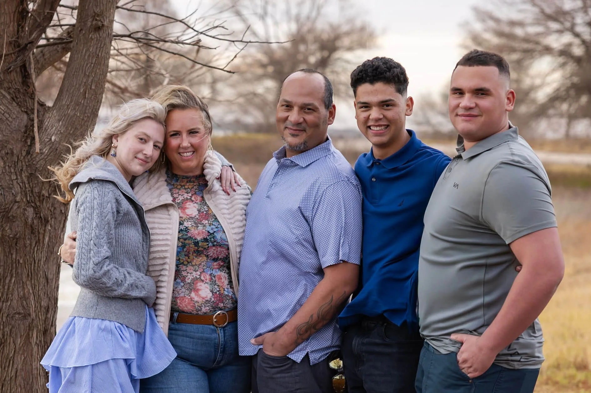 Family with adult children photographed together outdoors in North Texas
