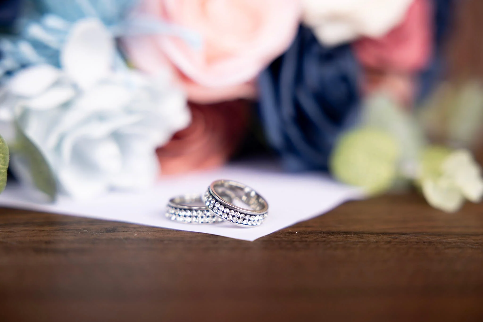 Wedding rings photographed with floral details by BeeCaptured