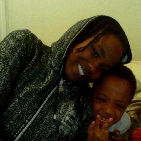 Taneshia smiling with her son Lhwhyh