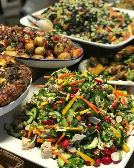 Platters of fresh salads, potatoes and frittata from the Meed kitchen
