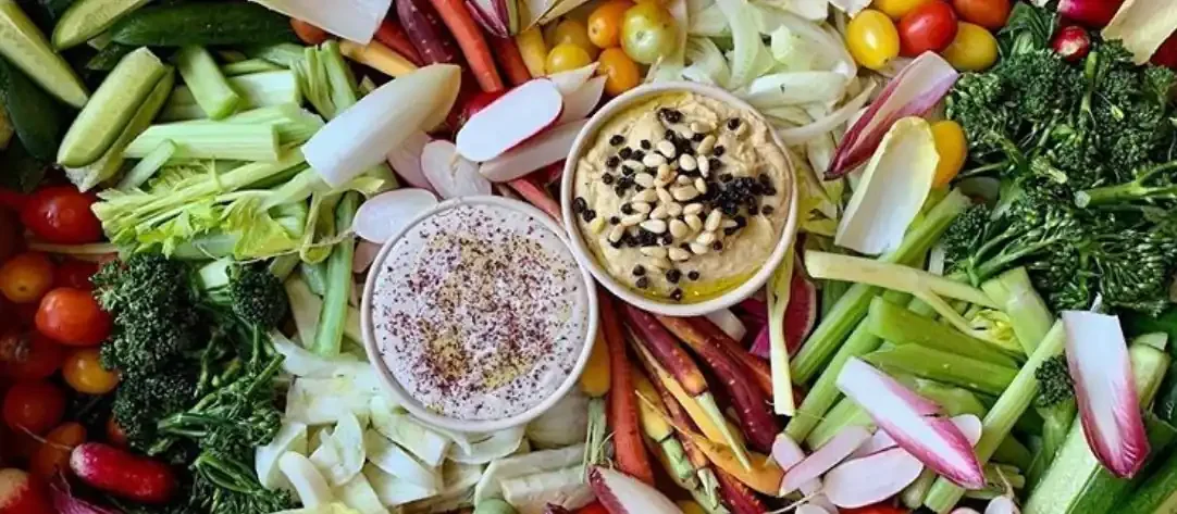 Crudités box of fresh vegetables with hummus and whipped dip