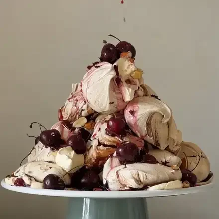 Meringue tower with cherries, cream and chocolate