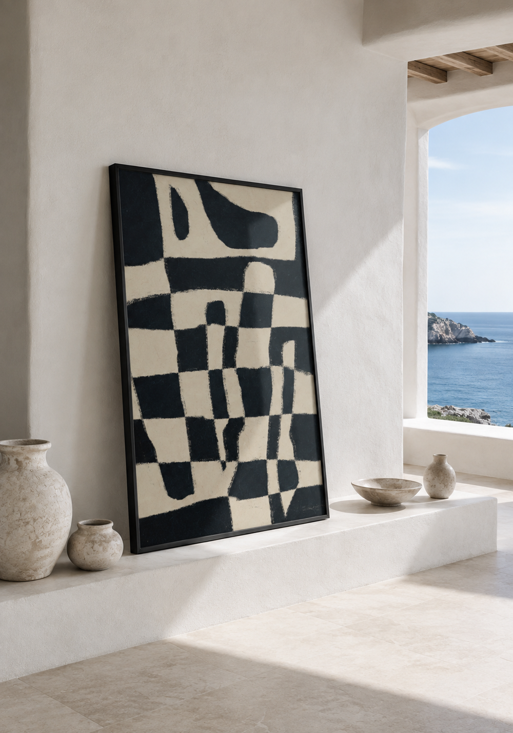 A black and ivory abstract work leaning in a coastal interior