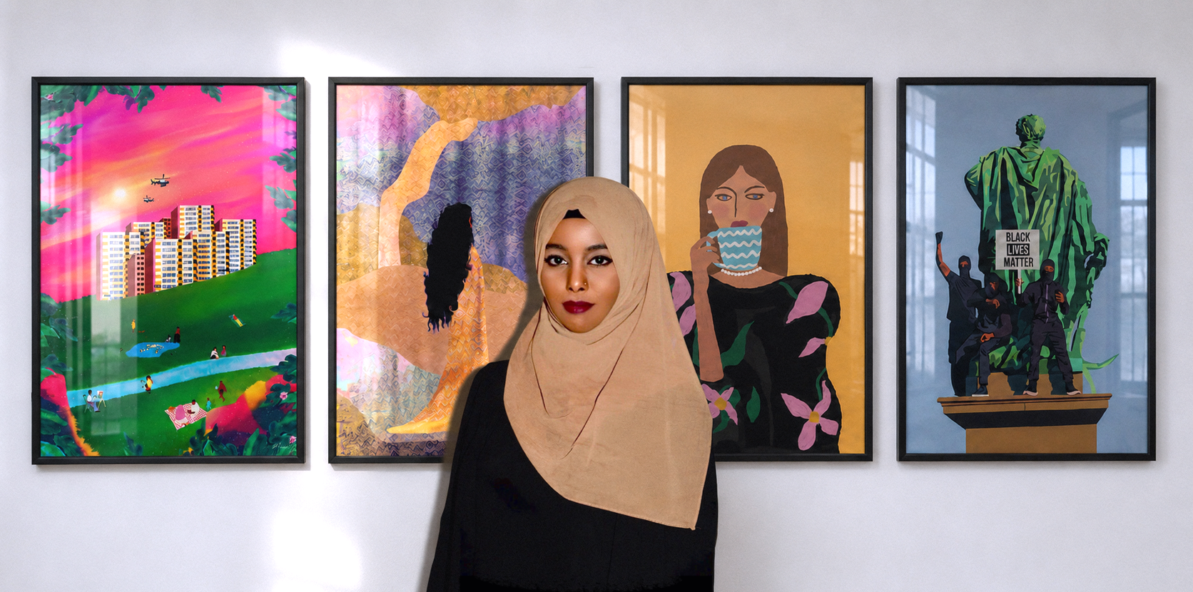 Artist Munira Yussuf standing in front of a selection of her artworks