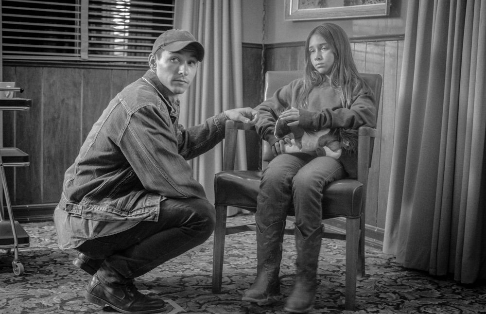 Actor and young performer rehearse an interior scene