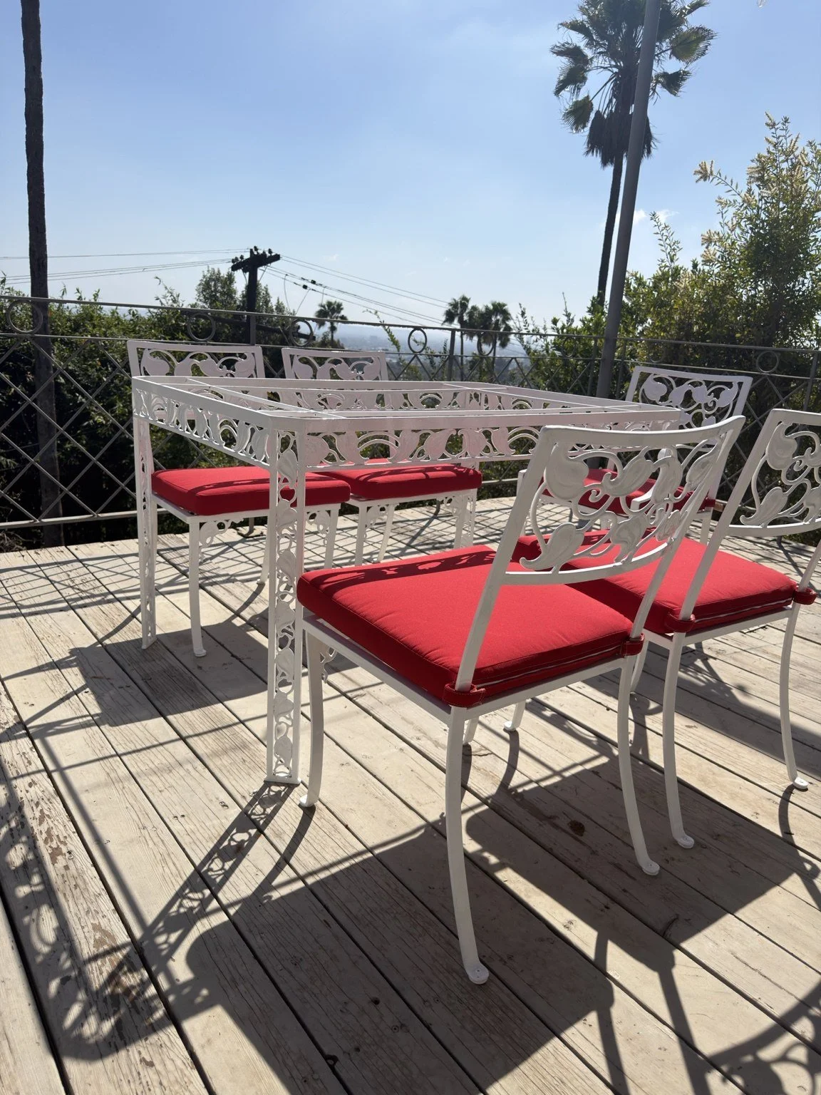 After powder coating and cushion replacement: white metal patio dining chairs fitted with custom red seat cushions